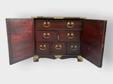 an image of a wooden chest of drawers with two doors open