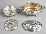 a group of four silverplated dishes on stands