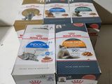 several boxes of cat food sitting on top of a white counter