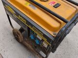 a small portable generator sitting on the sidewalk