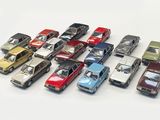 a lot of toy cars that are lined up on a table