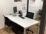 an image of a conference room with a desk and chairs