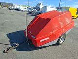 a red trailer with a trailer attached to it in a parking lot