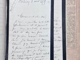 an old book with writing on it sitting on top of a table