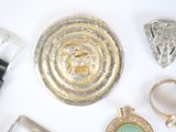 many different types of jewelry on a white surface