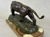 statue of a lion on a rock on a white background