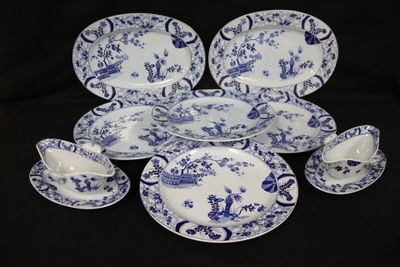 a group of blue and white plates and cups