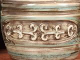 a close up of a vase on a table