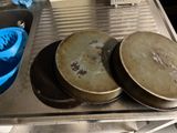 several pans of food sit on a metal tray in a kitchen