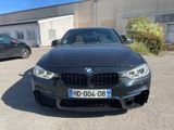 a black bmw car parked in front of a building