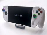 a close up of a video game controller with a cell phone on it