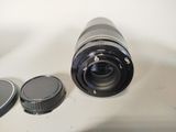 a camera lens sitting next to a cell phone on a table