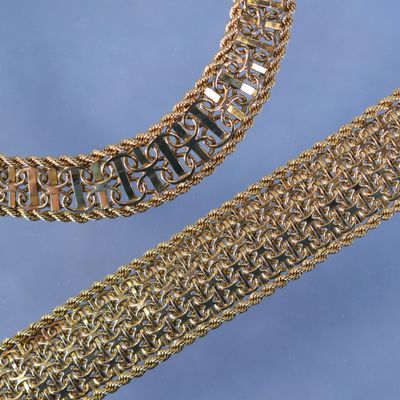 two gold chain bracelets and a gold chain bracelet on a blue background