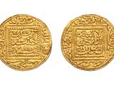two gold coins, one of which has a picture of a man and a woman on it