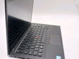 a black laptop with a red button on the keyboard