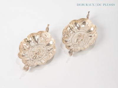 pair of silver plated dishes on a white surface with a white background