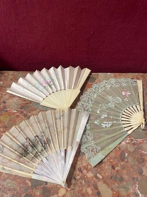 a table with a bunch of paper fans on it