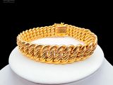 an image of a gold bracelet on a mannequin