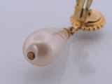 a close up of a pearl on a gold plated object