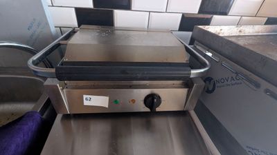 an image of a counter top grill with a purple towel on it