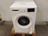 an image of a washing machine sitting on a pallet next to a wall