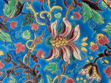 a close up of a decorative plate with flowers on it
