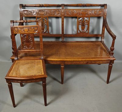 a wooden bench and two chairs sitting next to each other