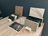 a table with a laptop, a magazine, and other items on it