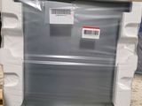 a white refrigerator sitting on top of a pallet in a warehouse