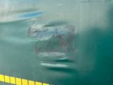 a close up of a green train with a yellow stripe