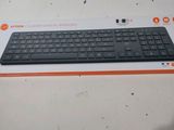 a black keyboard sitting on top of a box