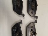 four pairs of brake pads on a white surface