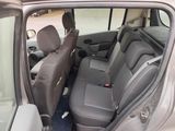 the back seats of a car with the door open and the driver ' s seat down