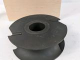 a close up of a spool with a wooden box in the background
