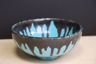 a blue and black bowl sitting on a table