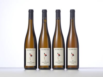 three bottles of wine sitting on top of a table next to each other