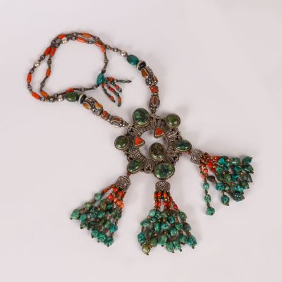 a close up of a necklace on a white surface