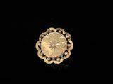 a close up of a gold ring on a black surface