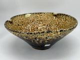 a close up of a black and gold bowl on a white background