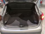 a trunk of a silver car with its trunk open
