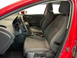 the interior of a red car with the front seats folded down