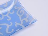 a blue plate with a white design on it