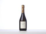 a bottle of wine sitting on top of a white table