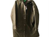 an image of a green jacket hanging on a hanger on a white wall