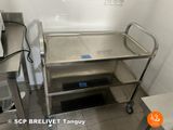 a stainless steel cart with a blue tag on it in a kitchen
