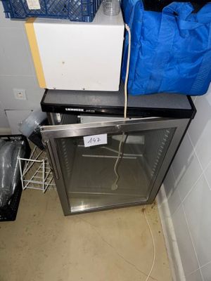 an image of a small kitchen with a refrigerator and a dishwasher