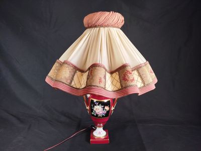 a lamp that is sitting on a table with a black background