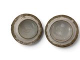two bowls that are sitting side by side on a white surface