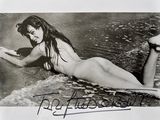 une photo en noir et blanc d'une femme allongée sur une planche de surf