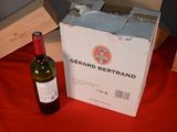 a bottle of wine sitting next to a box of wine